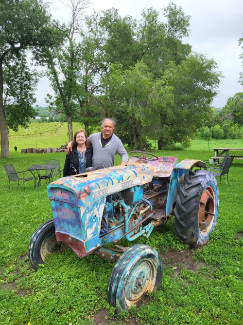 Photo of S. T. and Mary with an old tractor