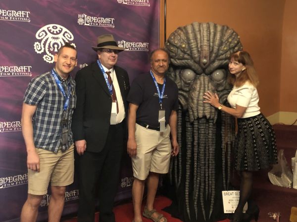 Tony LaMalfa, Adam Bolivar, S. T. Joshi, and Katherin Kerestman with the Cthulhu statue at the H. P. Lovecraft Film Festival & CthulhuCon 2023